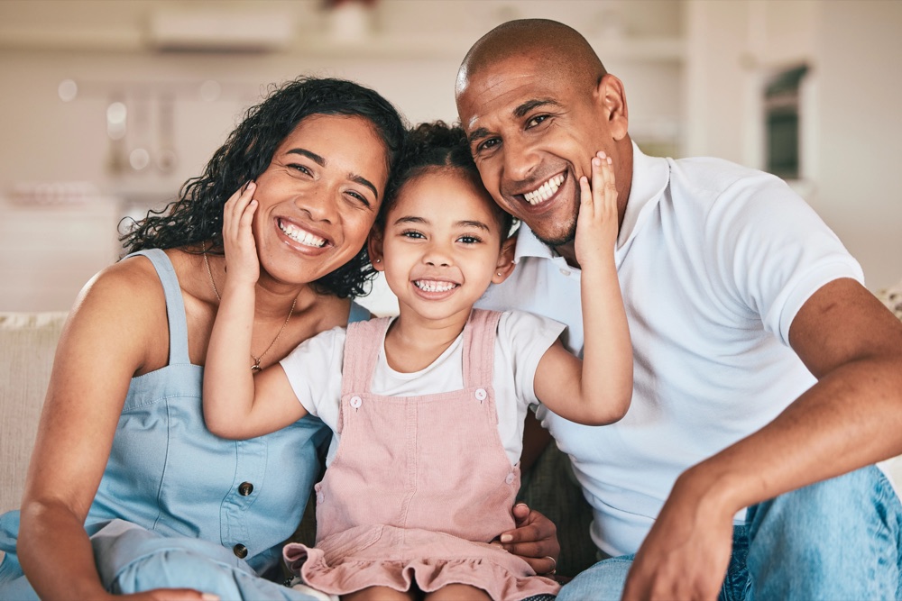 Smiling family together at home